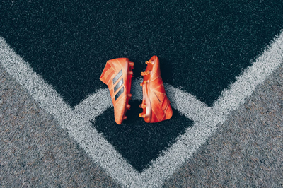 pair of soccer cleats on an artificial turf surface